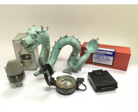 A military compass, a metal figure of a Chinese dragon etc.
