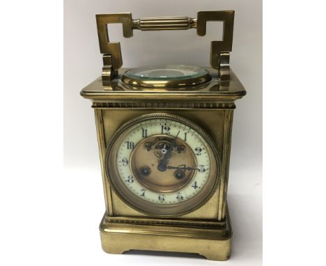 A brass cased carriage clock inset with barometer.