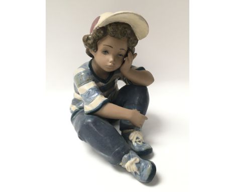 A Lladro figure of a boy titled Long Day figurine.