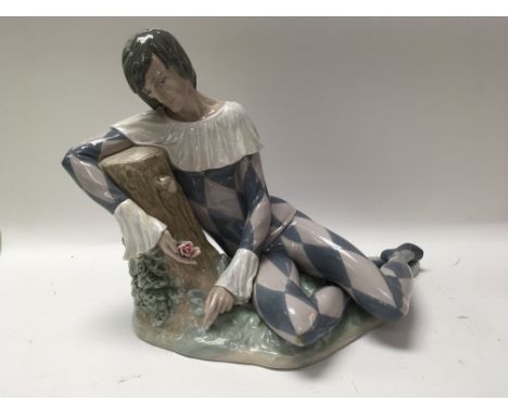 A Lladro figure in the form of a harlequin. With box .