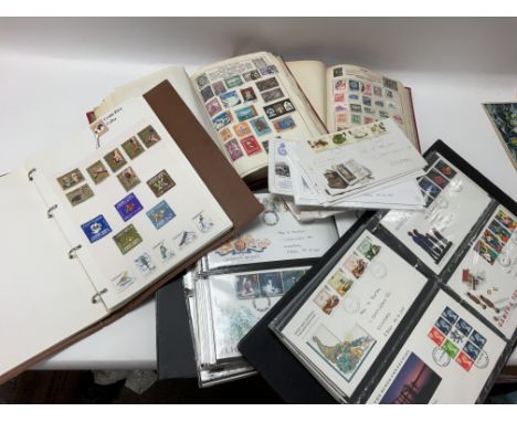 A box containing stamp albums and first day covers.