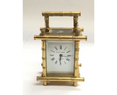 A small brass carriage clock with bamboo style decoration, approx height 11cm.