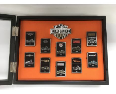 A cased set of Harley Davidson Zippo lighters.