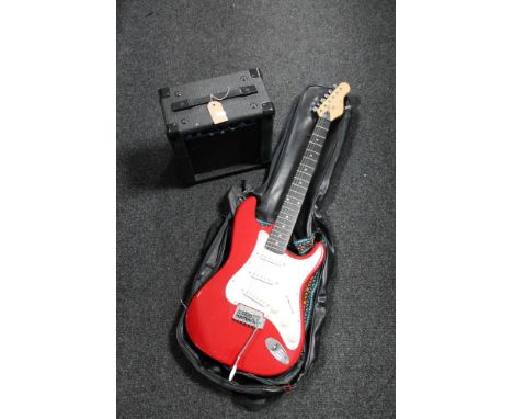 An Encore electric guitar with carry strap together with a KLA 10 lead amplifier with carry strap 