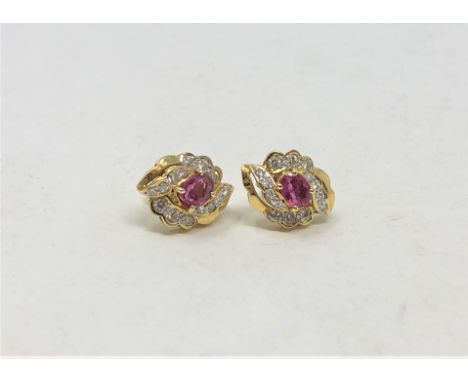 A pair of 18ct gold diamond and ruby earrings. (2)