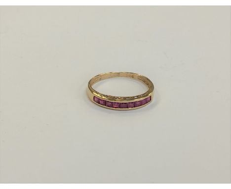 A 14ct gold ruby half eternity ring, size N1/2