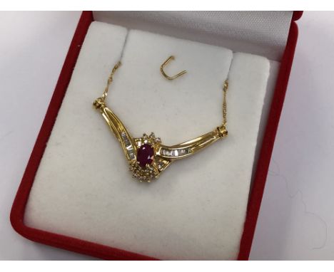 A 10ct gold ruby and diamond pendant on 18ct gold chain