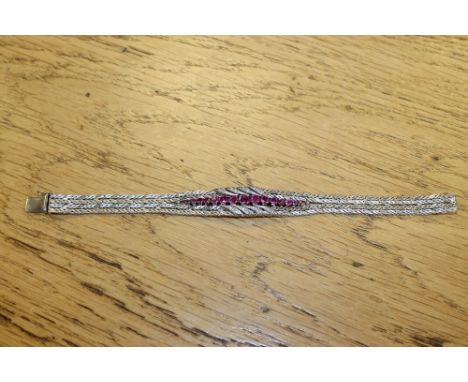 An 18ct white gold ruby and diamond set bracelet CONDITION REPORT: 38.2g. Length 19cm. Stamped '750' and 'K 18'. In good cond