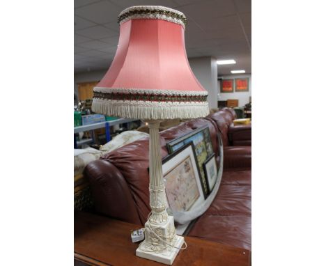 A cream carved table lamp with tassel shade 