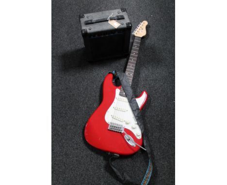 An Encore electric guitar with carry strap together with a KLA 10 lead amplifier  CONDITION REPORT: This item is used. Postag
