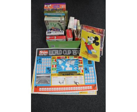 A box of vintage board games, plastic air fix soldiers, mechanical air transport helicopter, Disney poster, World cup 1970's 