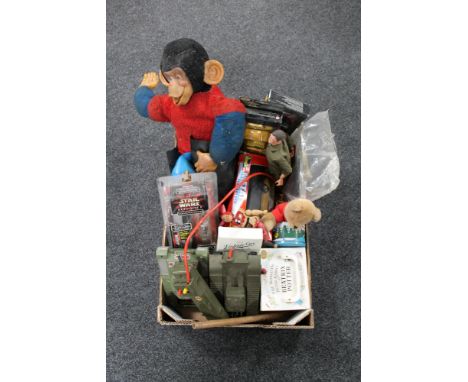 A box of toys, Monkey soft toy, Action man, battery operated tanks, Beatrix Potter book set 