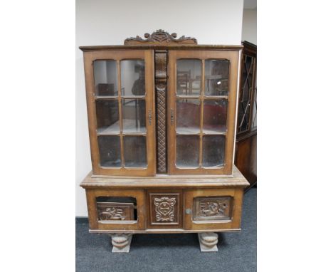 A 20th century continental carved oak display cabinet  CONDITION REPORT: Height 184 cm x Depth 44 cm and width 135 cm. The it