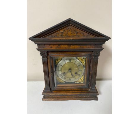 An antique pine cased bracket clock with brass and silvered dial with pendulum 