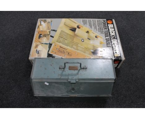 A boxed Black and Decker power tool table together with a metal tool box 