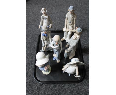 A tray containing two Nao figures of a girl with hand mirror, girl with flower, together with a further five Spanish figures 