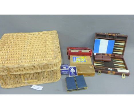 Basket containing a quantity of vintage playing cards, a chess set, cribbage board etc,.(a lot) 