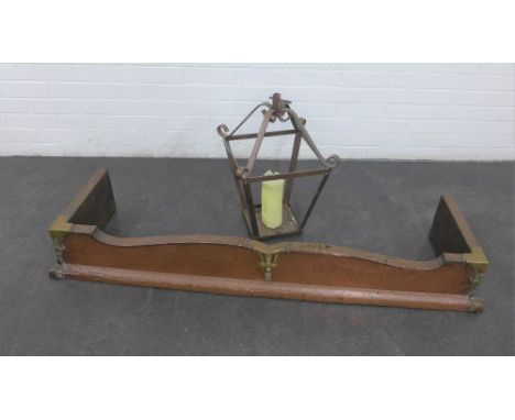 Copper and brass fender, together with a hanging lantern style candle holder (2) 