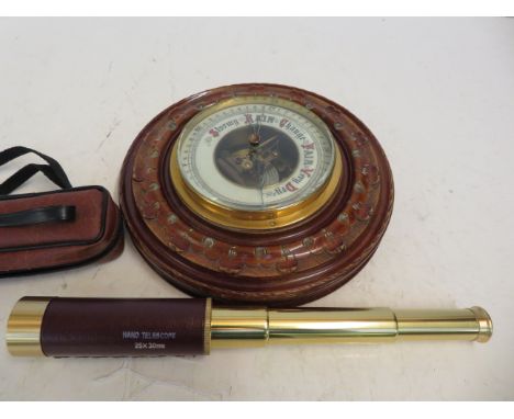 A wall barometer together with a brass and leather telescope