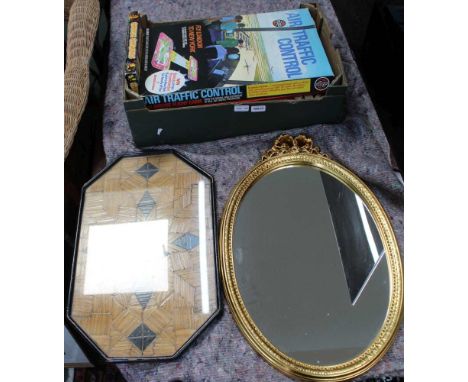 A BOX CONTAINING A SELECTION OF BOXED GAMES together with an oval wall mirror, and a wooden framed marquetry tray 