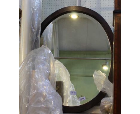 A PLAIN OAK FRAMED OVAL BEVEL PLATE WALL MIRROR 