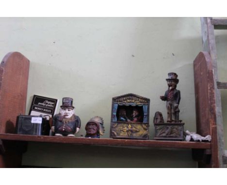 A SELECTION OF VARYING VINTAGE MONEY BANKS to include painted cast metal, together with an antiques pocket guide 
