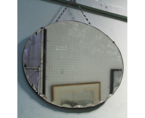A SCALLOPED EDGED OVAL WALL MIRROR together with a thistle decorated plain plate mirror 