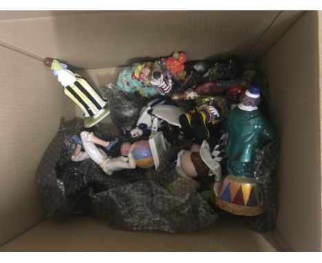 A box of ceramic clown figures and clown toys.- NO RESERVE