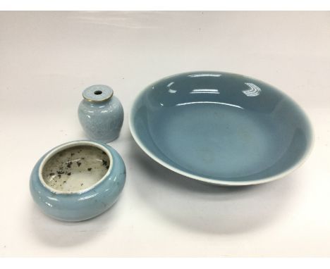 Three pale blue ceramic items comprising a dish, approx diameter 16.5cm, bud vase and a small pot. Shipping category D.