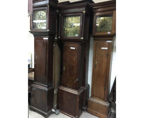 An oak long case clock, the brass dial having Roman numerals with Moon roller, second subsidiary dial. S. Ashton, Bredbury