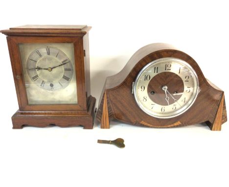 An oak mantle clock with a silver dial and a walnut mantle clock. Postage D