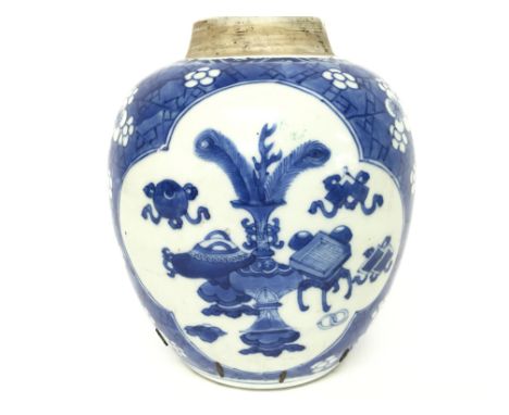 An Kangxi period porcelain blue and white ginger jar , decorated with panels of precious objects and cherry blossom on a crac