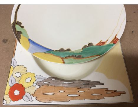 Two Clarice Cliff plates decorated with fur trees and house and trees .