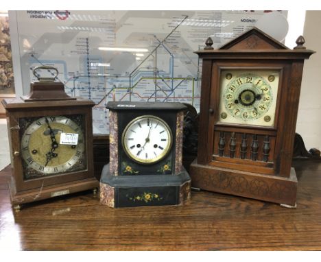 A slate mantle clock with Roman numerals and two other mantle clocks