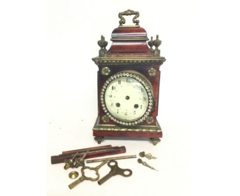 A gilted brass and tortoiseshell mantle clock ,dimensions 12x20x9cm in need of restoration.