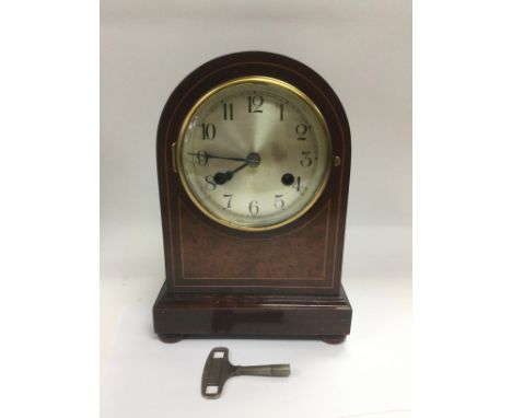 An eight day inlaid mahogany mantle clock, approx height 26cm. Comes supplied with key. Shipping category D. NO RESERVE