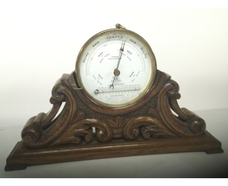 A carved walnut barometer stand with attached Barometer Cragg of Colchester. Length of stand 34cm NO RESERVE