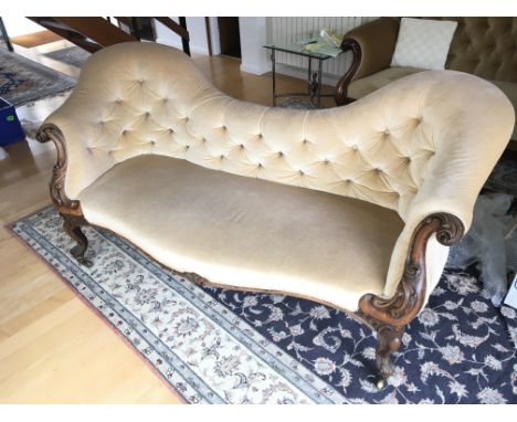 A Victorian walnut sofa with a shaped back button down upholstery and shaped and carved scroll walnut ends. No Reserve length