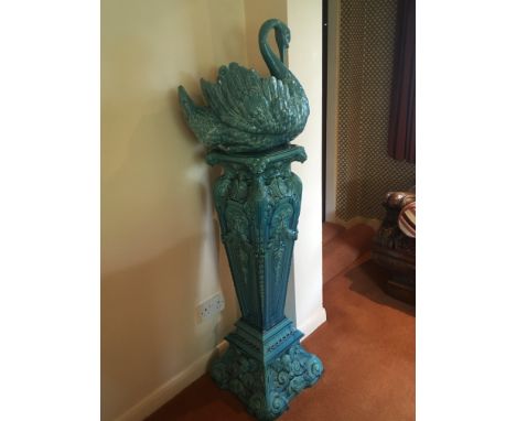 A Burmantofts blue glazed elaborate jardiniere and stand in the form of a swan. The base with a crack. Height 153cm