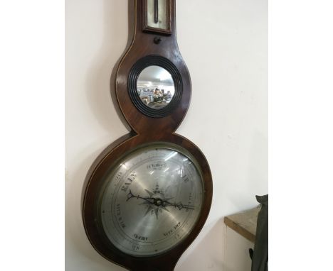 A Georgian mahogany barometer with applied thermometer maker Manuell Wisbeach .