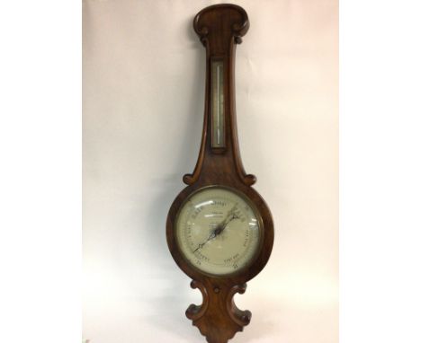 A Salmon and sons walnut barometer. 32cm wide by 103cm tall. Postage D