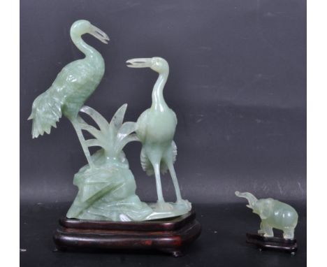 A large vintage late 20th century finely carved green stone ornament of two herons raised on a wooden base. Together with a j