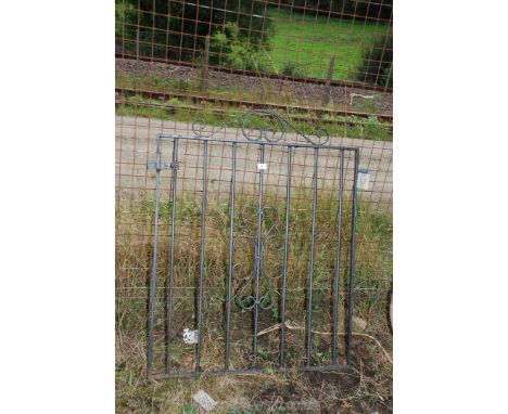 A metal pedestrian gate, 36" wide x 42" high.