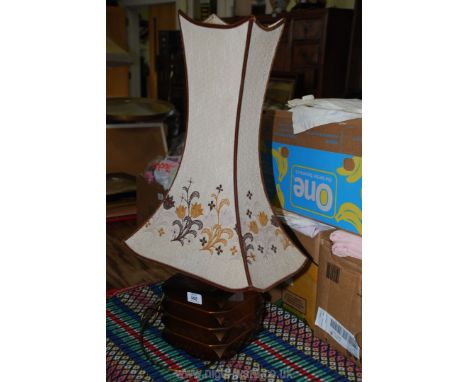 Ceramic based table lamp with an unusual tapered shade.