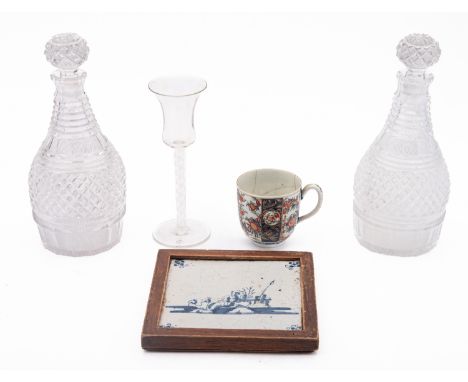 A pair of cut-glass decanters and stoppers, 20cm; an opaque twist wine glass, a blue and white delftware tile and a First Per