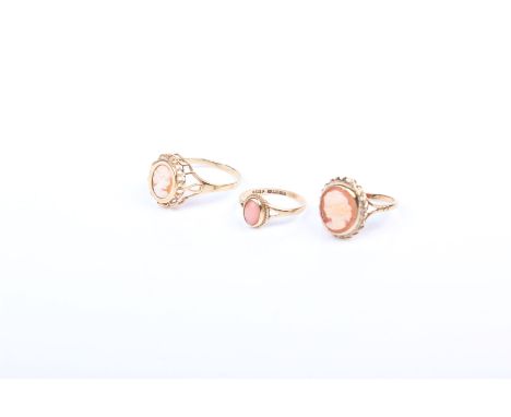 Three 9ct gold rings,  two shell cameo rings together with a 9ct gold ring set with oval pink coral cabochon. 6.6g gross 