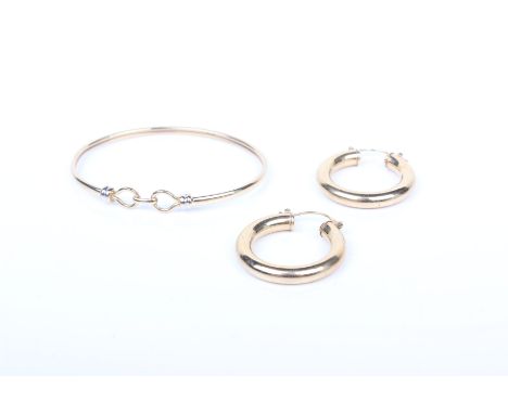 A 9ct bangle bracelet together with a pair of 9ct hoop earrings. 8.5g gross.