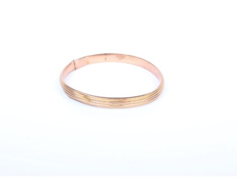 A 9ct gold bangle. 12.1 g 