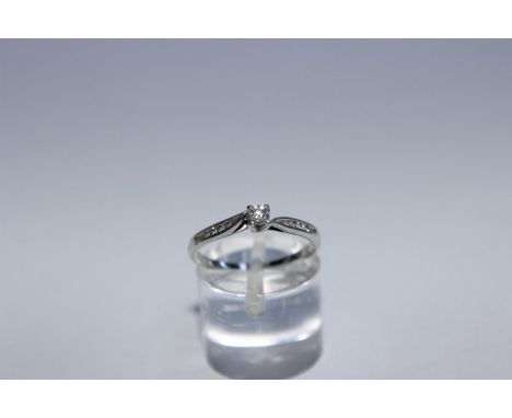 A 9ct white gold and diamond ring. Central brilliant cut diamond with single cut diamond shoulders. Size K 1.8g