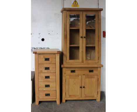A light oak, glazed-top dresser (h: 200cm w: 85cm d: 35cm) and a five drawer chest (h: 110 w: 55cm d: 40cm). 
